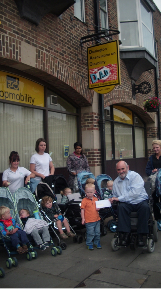 Gordon Pybus receiving cheque from one of the children who raised funds for DAD