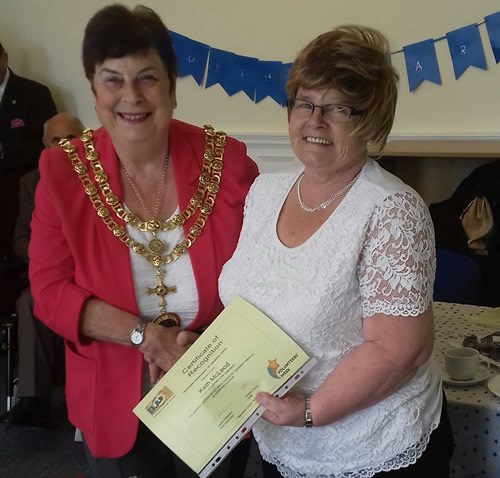 Photo showing Kath McLeod receiving her certificate from Mayor Copeland