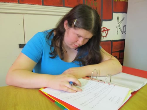 Photo showing Amy writing recipies at the Hub