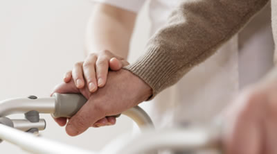 Male hand holding onto a support with a hand on top of his