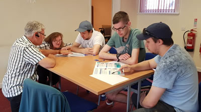 group of people sitting around a desk