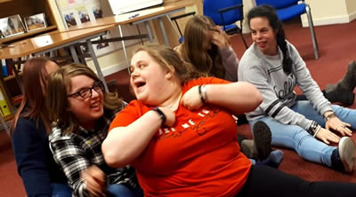 people sitting on the floor having a laugh